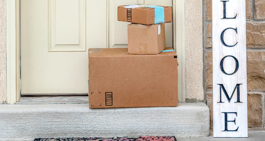 Boxes by the door of a residence with a welcome sign in Huntsville